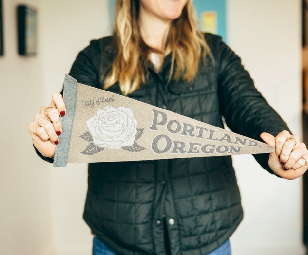 A person holds up a pennant that reads 