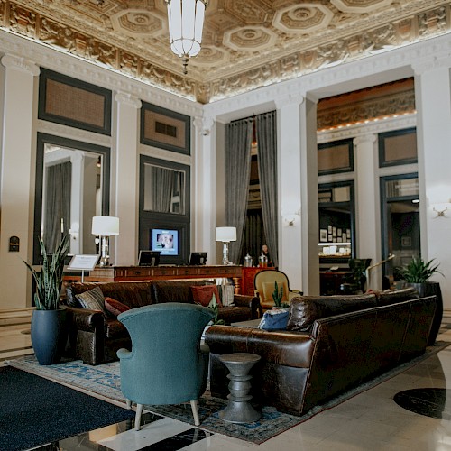 A luxurious lobby with elegant furniture, high ceilings, and decorative lighting.